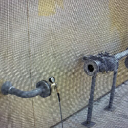 Flexible industrial plumbing pipes and fittings in a construction or maintenance setting.